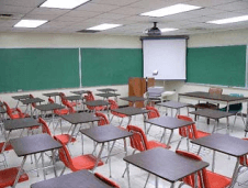 Classroom with gray desks and orange chairs